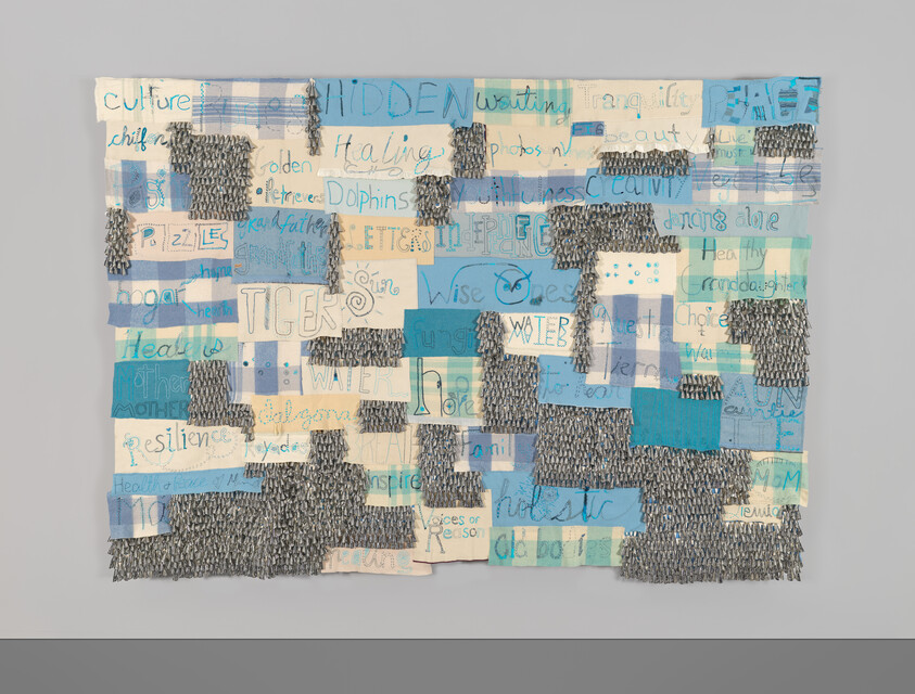 A patchwork textile with blue and cream squares, handwritten words like “TIGERS,” “WATER,” and “resilience” visible.