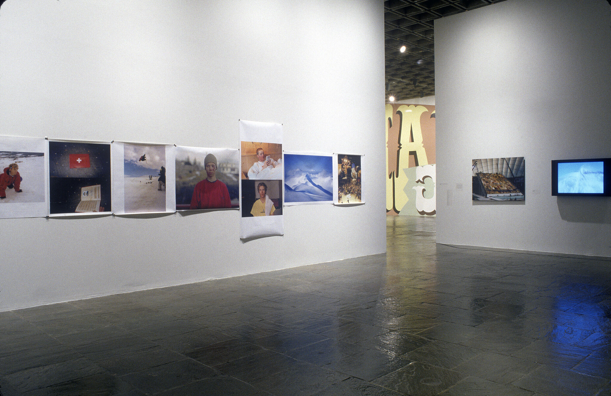 A gallery filled with photographs on display.