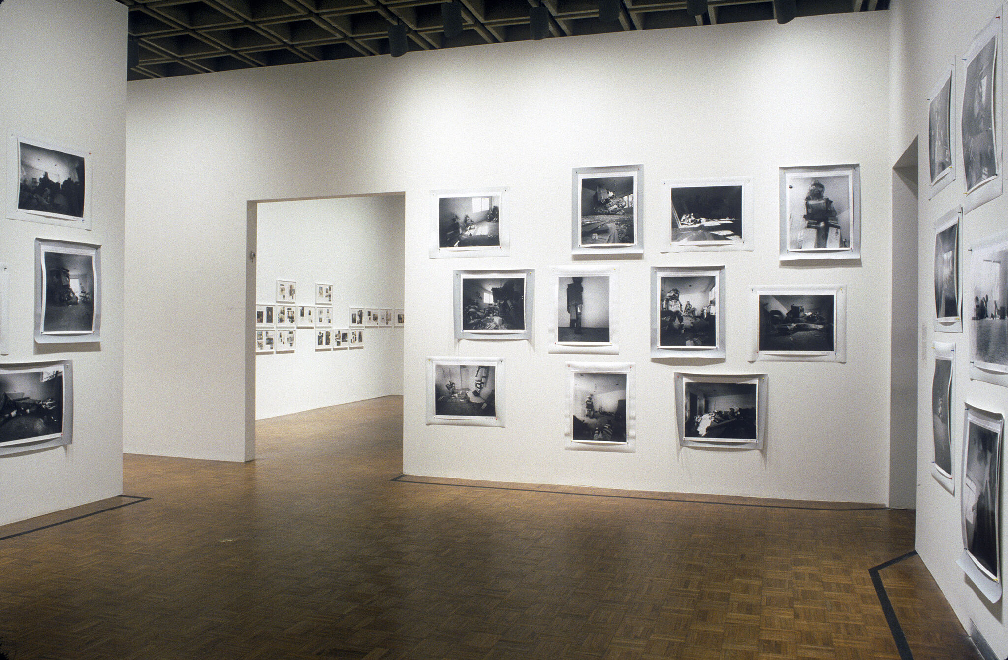 A gallery filled with black and white photographs displayed on the walls.