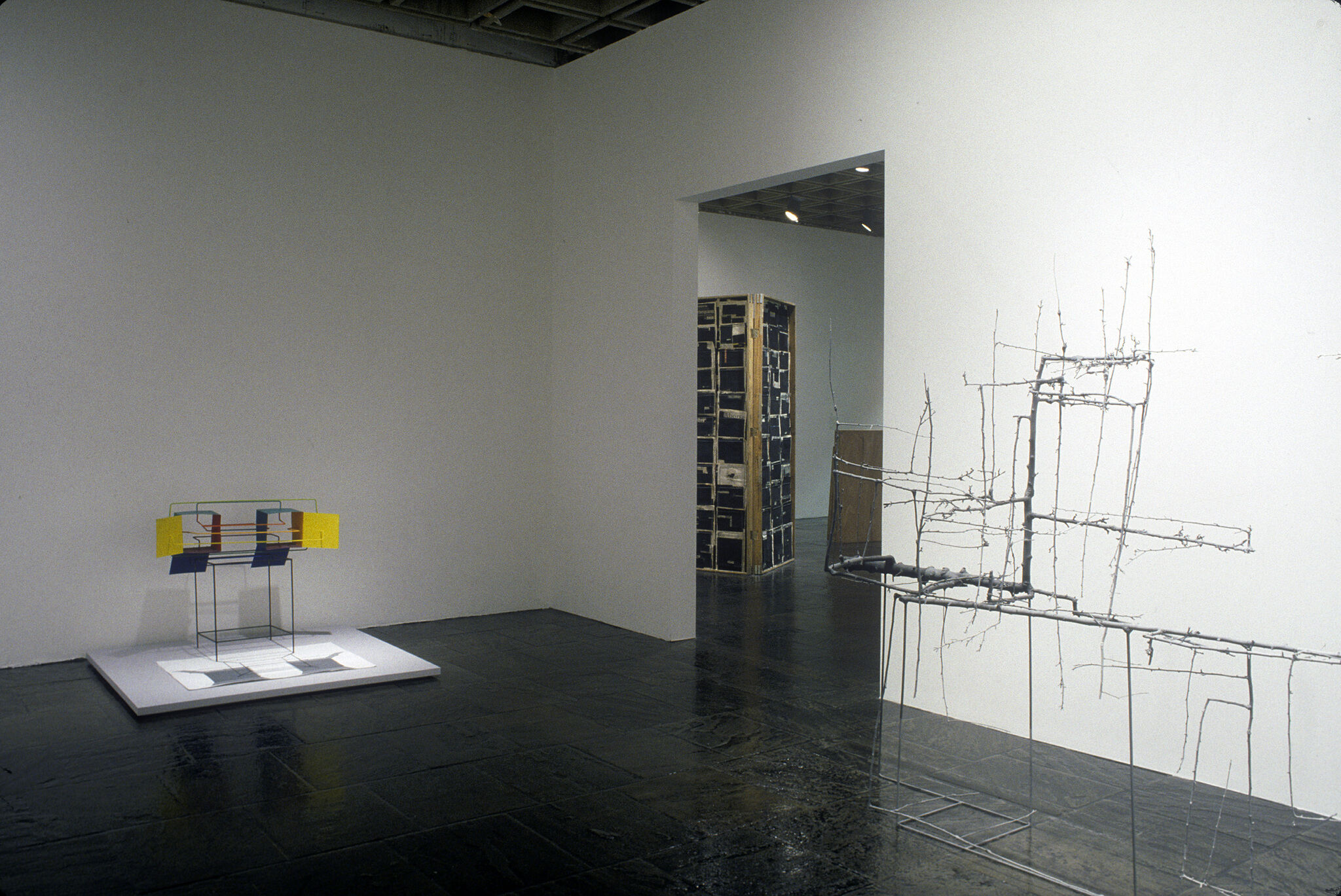 A gallery with wire sculptures on display.