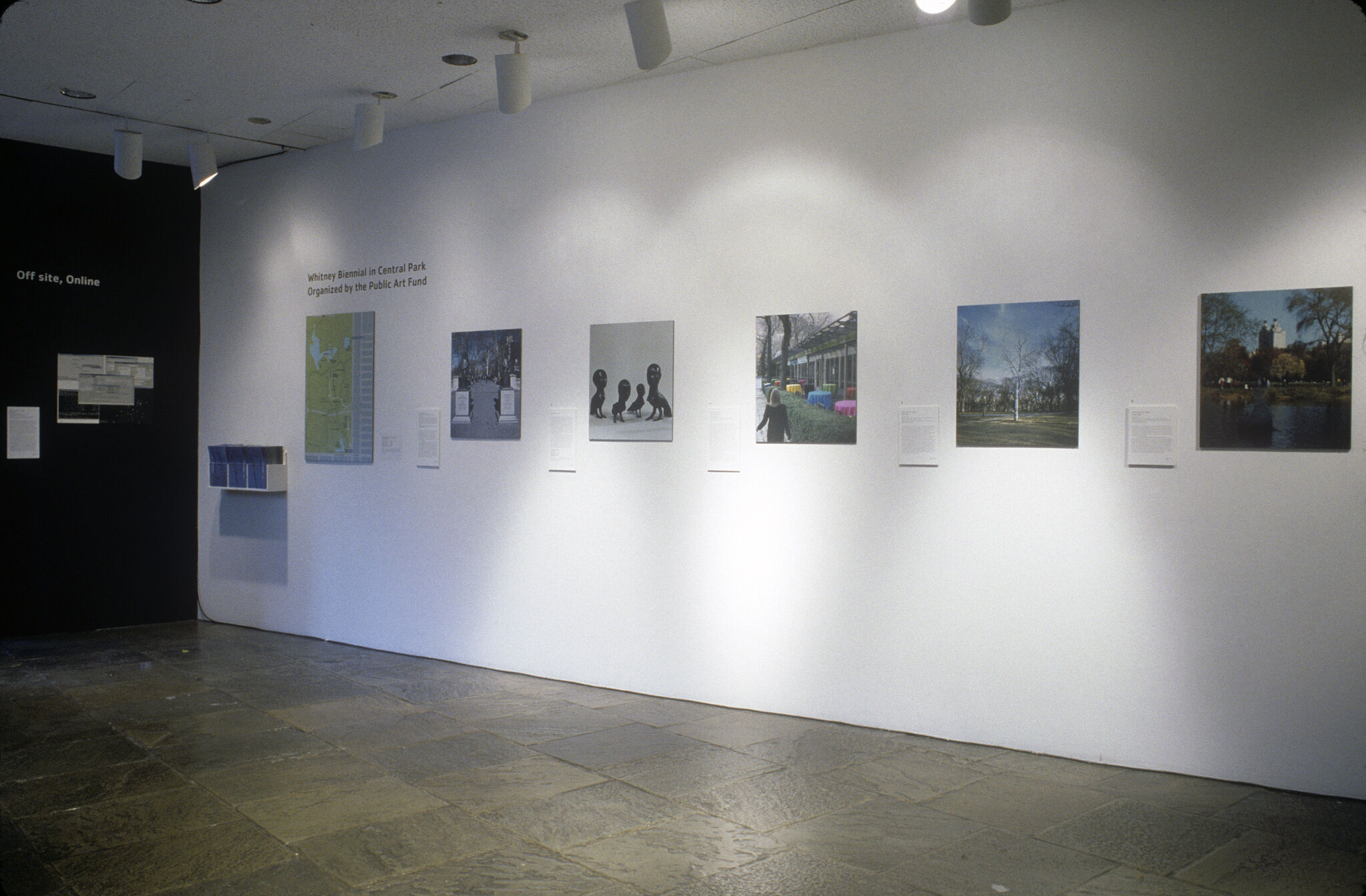 A gallery with photographs displayed on the wall.