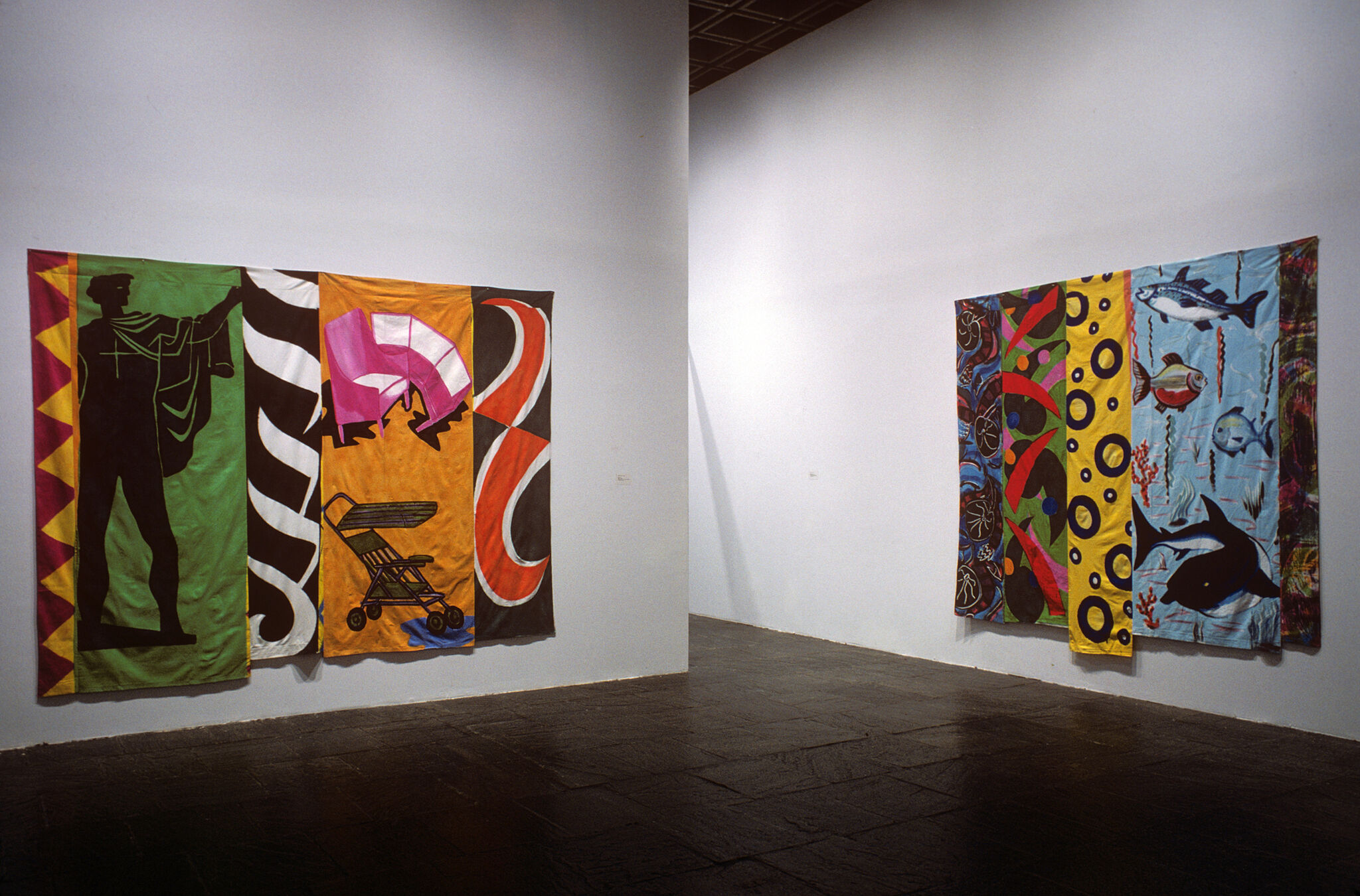 Two works of art hanging in a gallery.