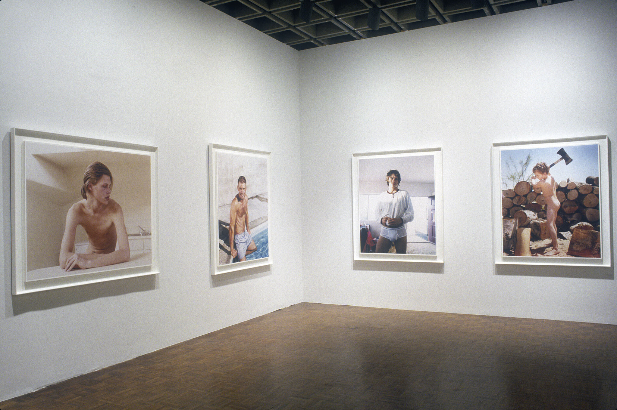 Four portrait photographs displayed in a gallery.