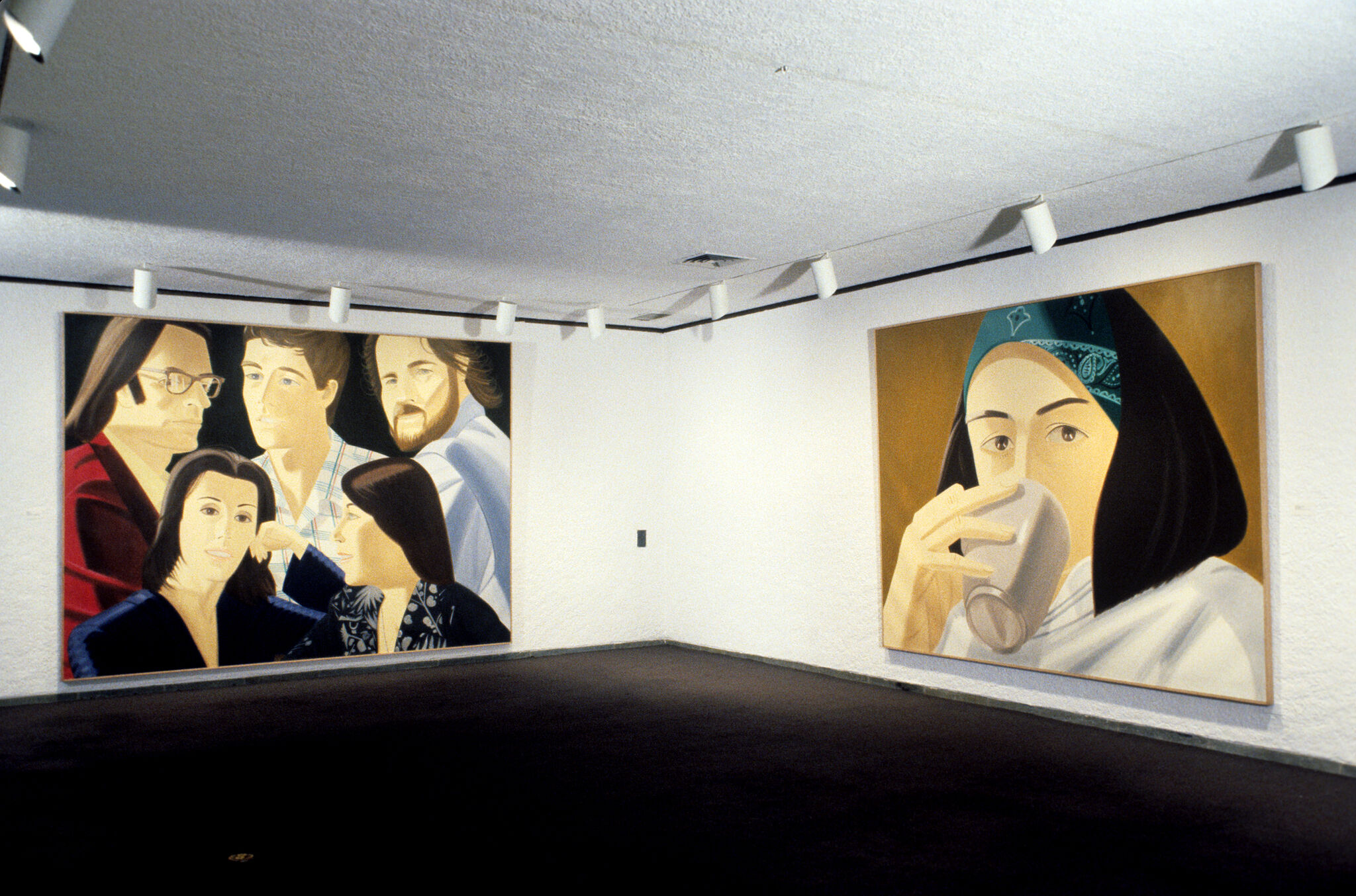 Two paintings hanging in a gallery.