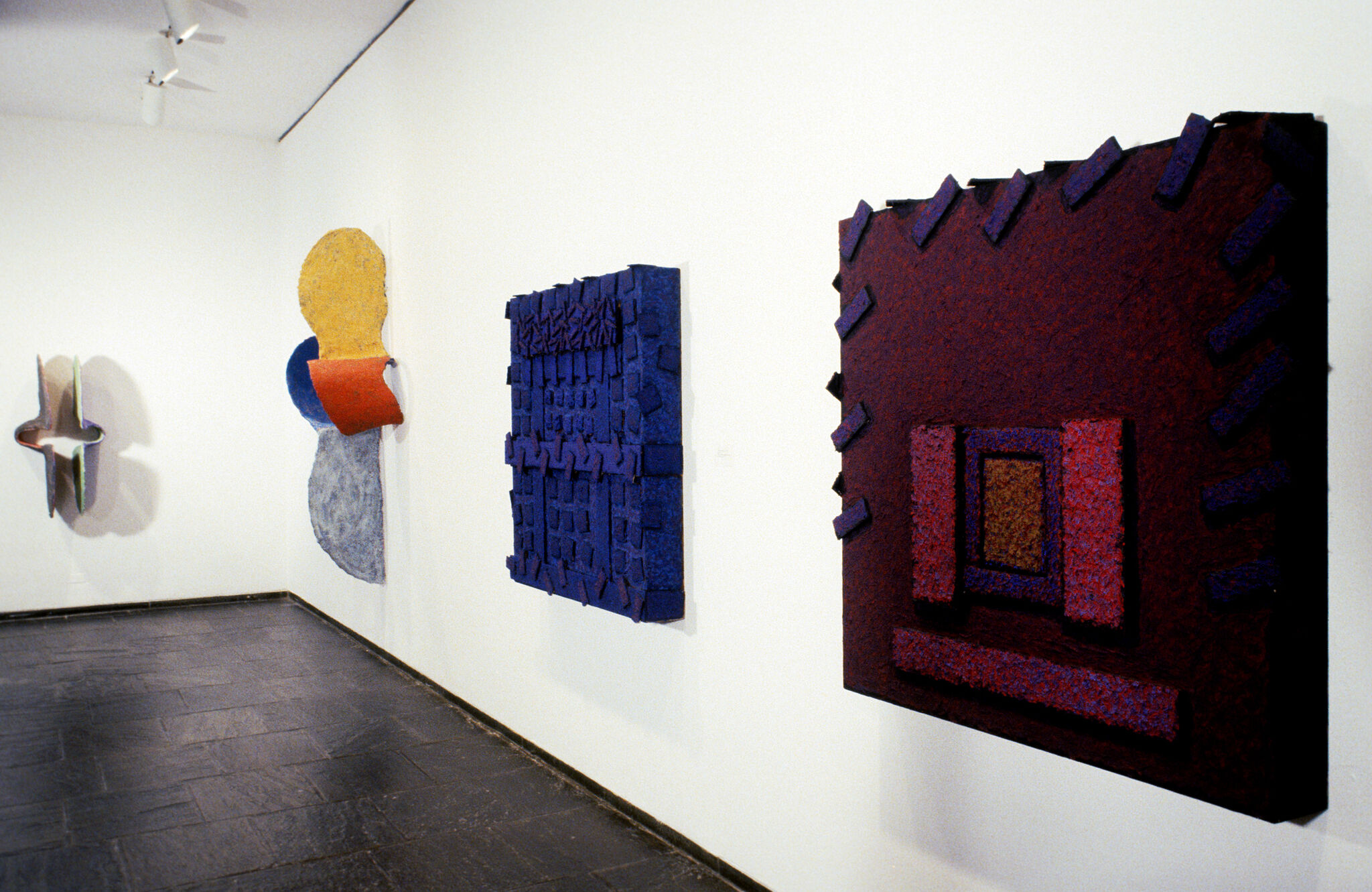 Works of art hanging in a gallery.