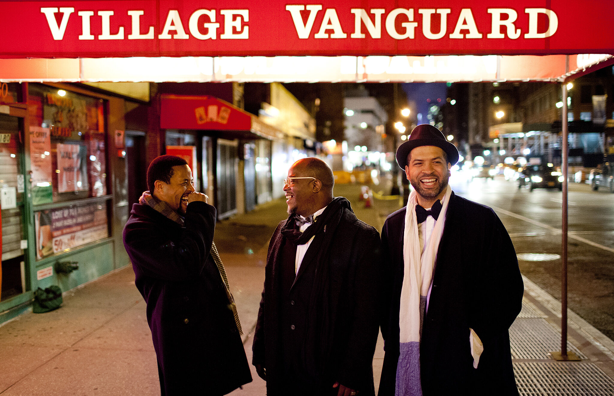 A photo of Nasheet Waits, Tarus Mateen, and Jason Moran outside the Village Vanguard