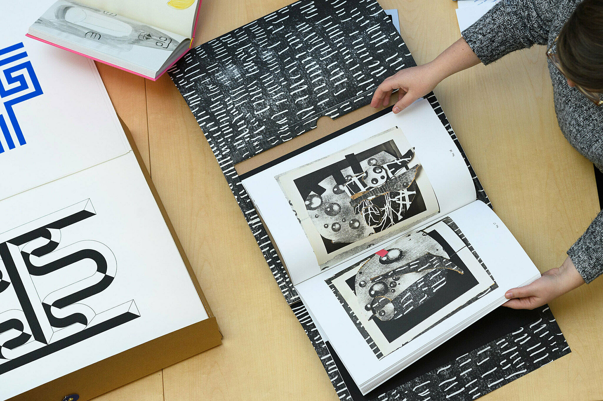 Looking at books on a table.