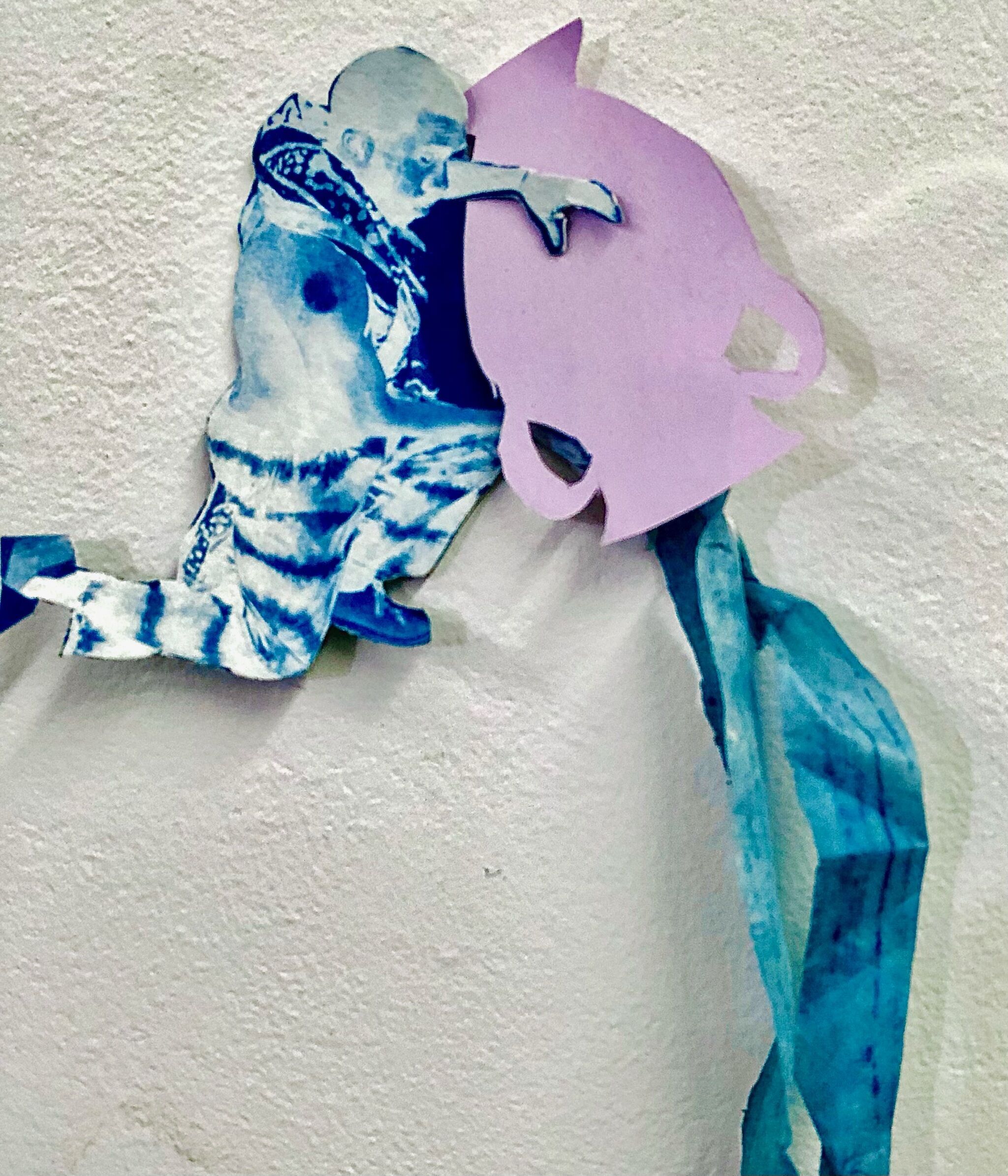 A paper cut-out of a person emptying a water pitcher. 