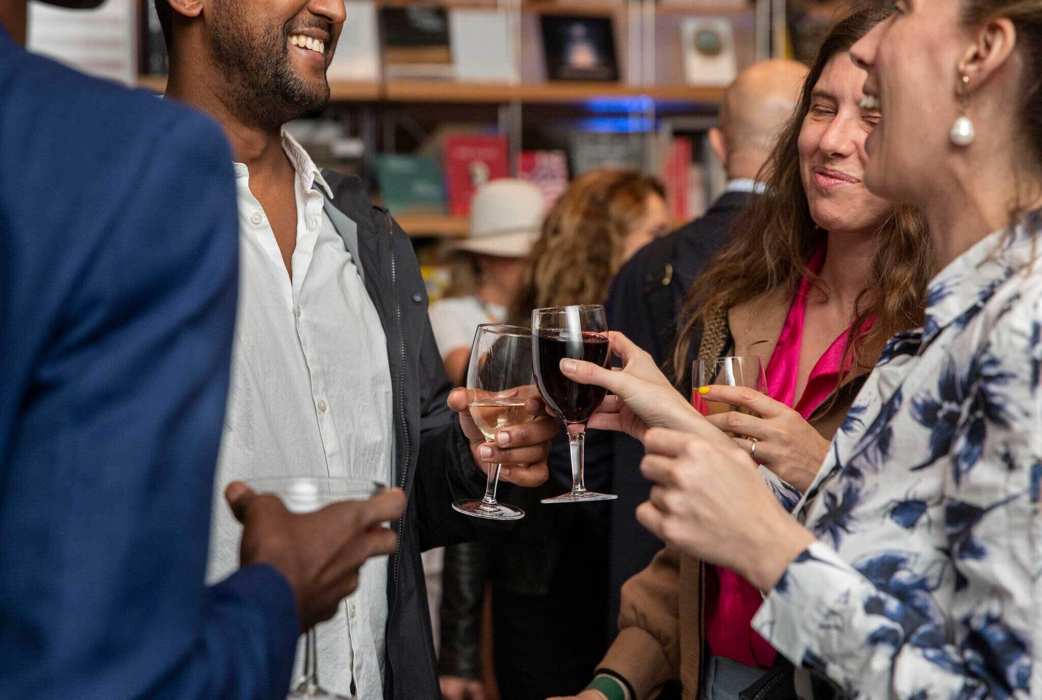 Group of people talking with drinks in hand
