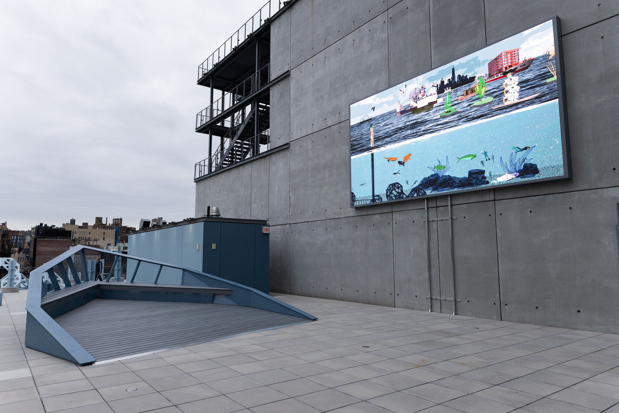 Large digital screen on a building wall displays an underwater and cityscape scene.