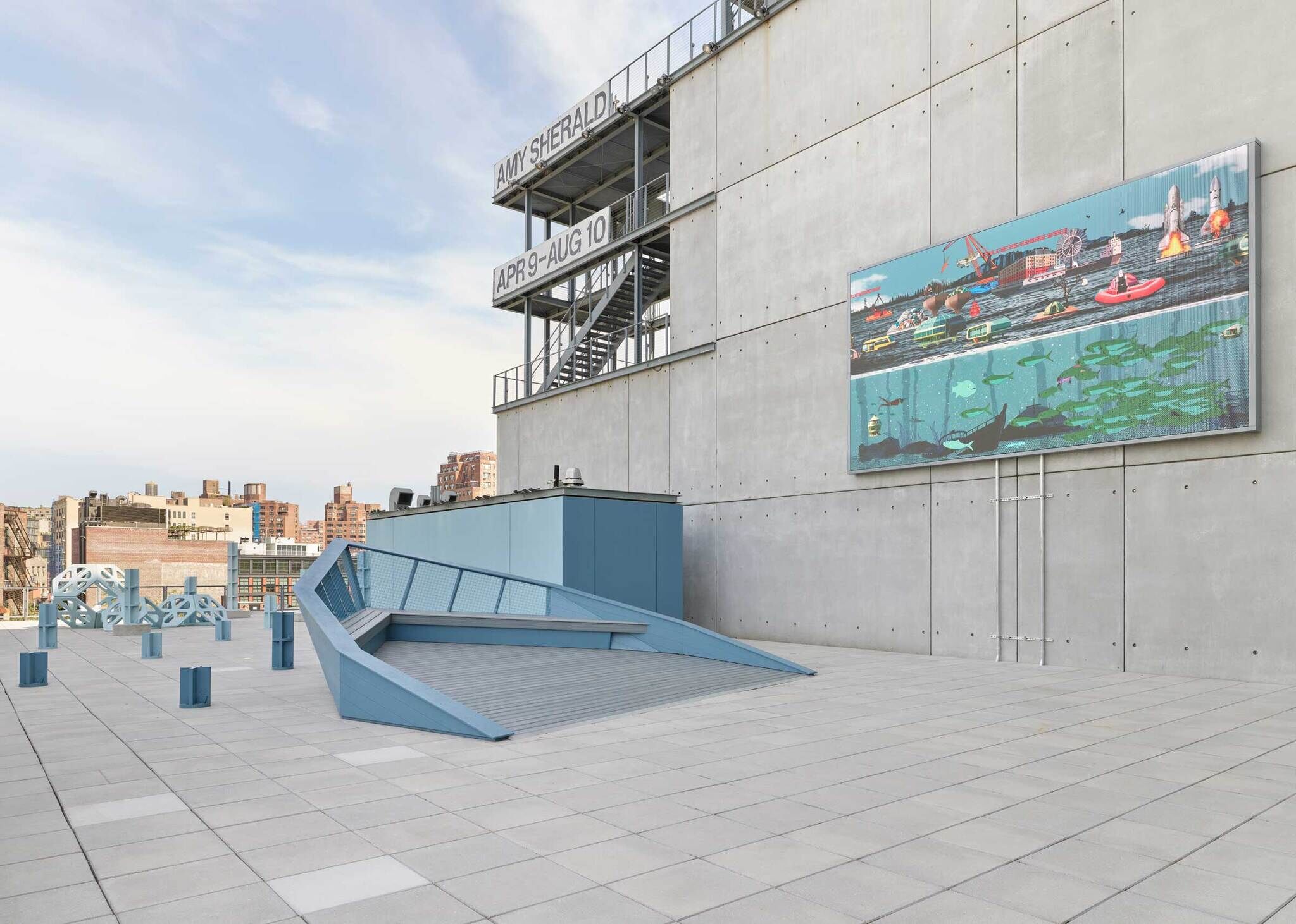 Rooftop terrace with a large digital art screen and signs reading “AMY SHERALD” and “APR 9–AUG 10.”