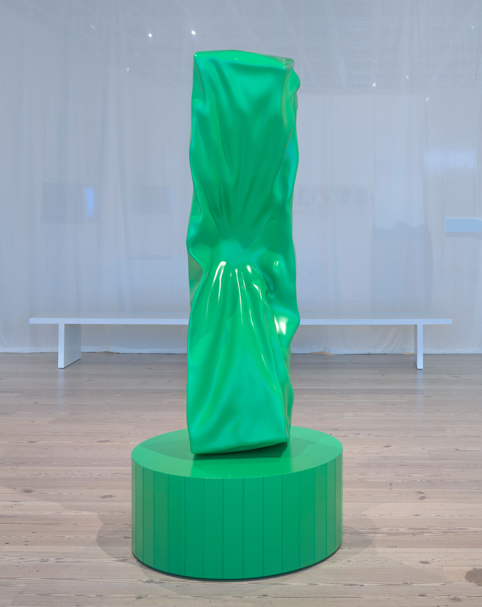 A crushed metal-like object with a ball attached to the midsection.