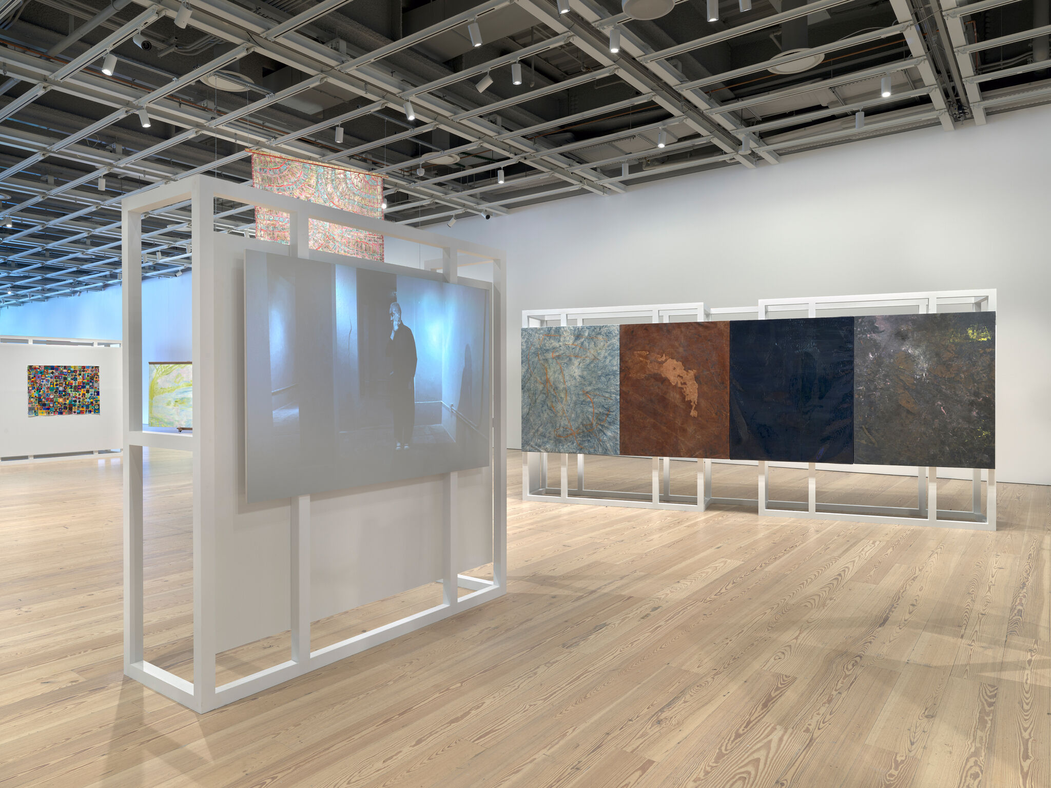 Multiple artworks in a light-filled gallery.