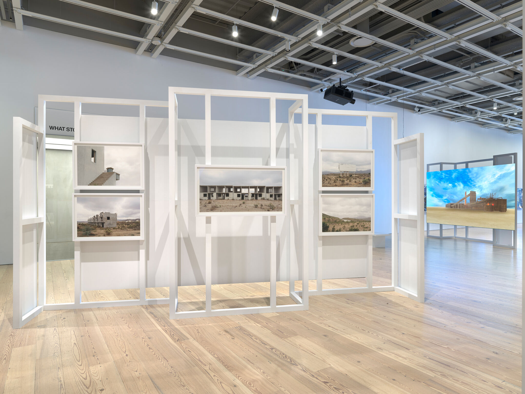 Photographs displayed in the center of a light-filled gallery.