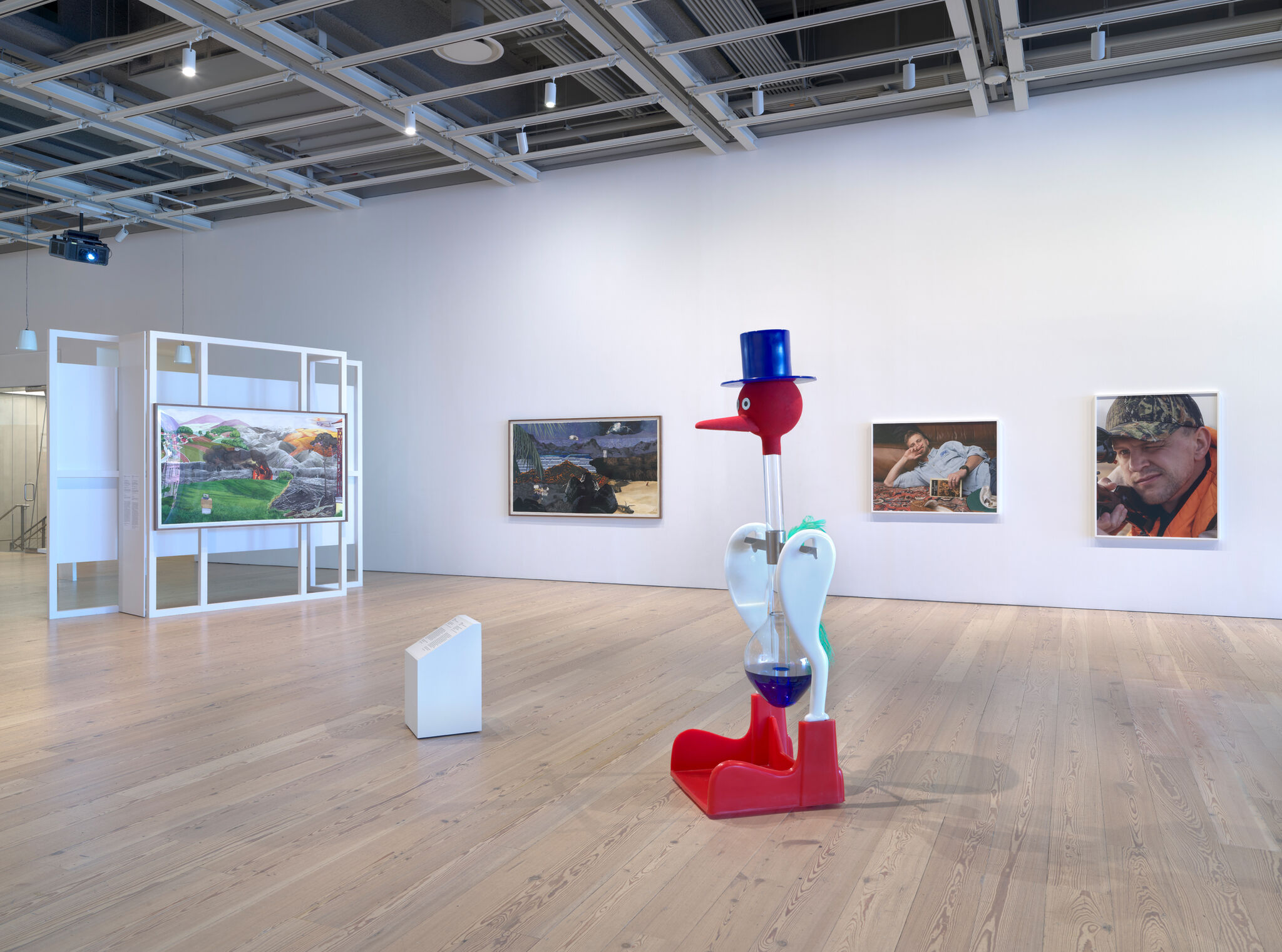 Multiple artworks in a light-filled gallery.