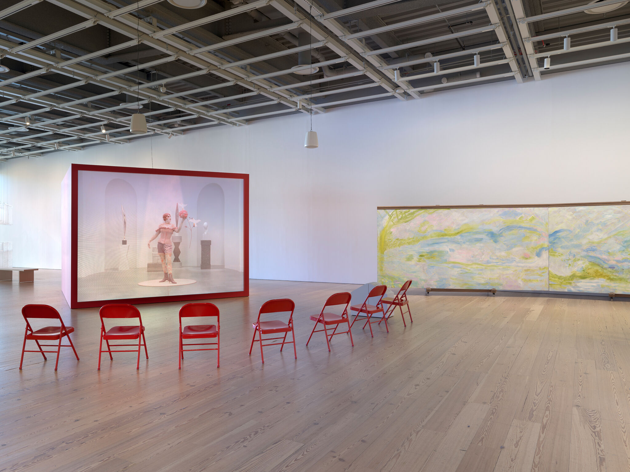 Multiple artworks in a light-filled room.