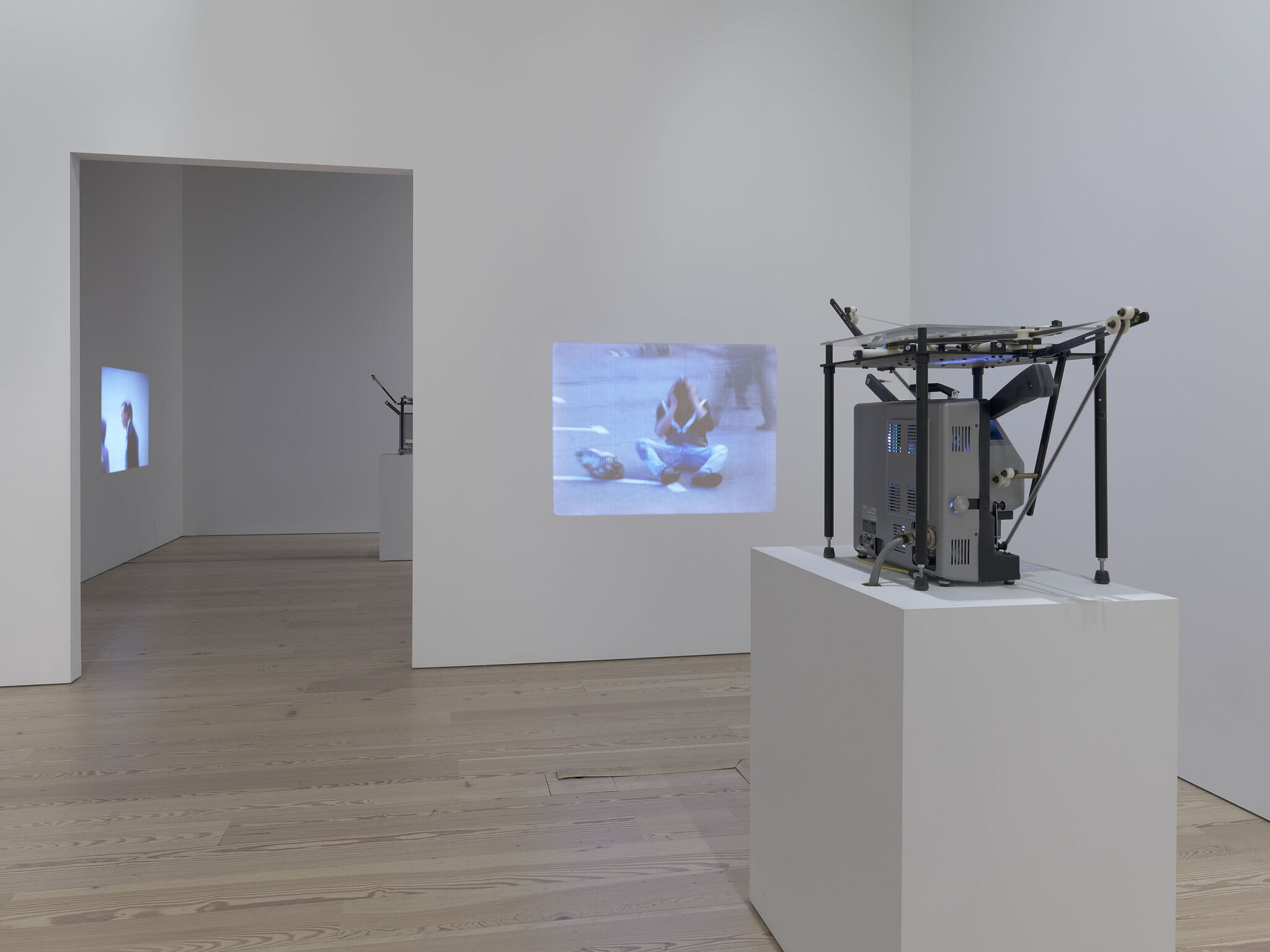 A gallery with a video projected on a wall.