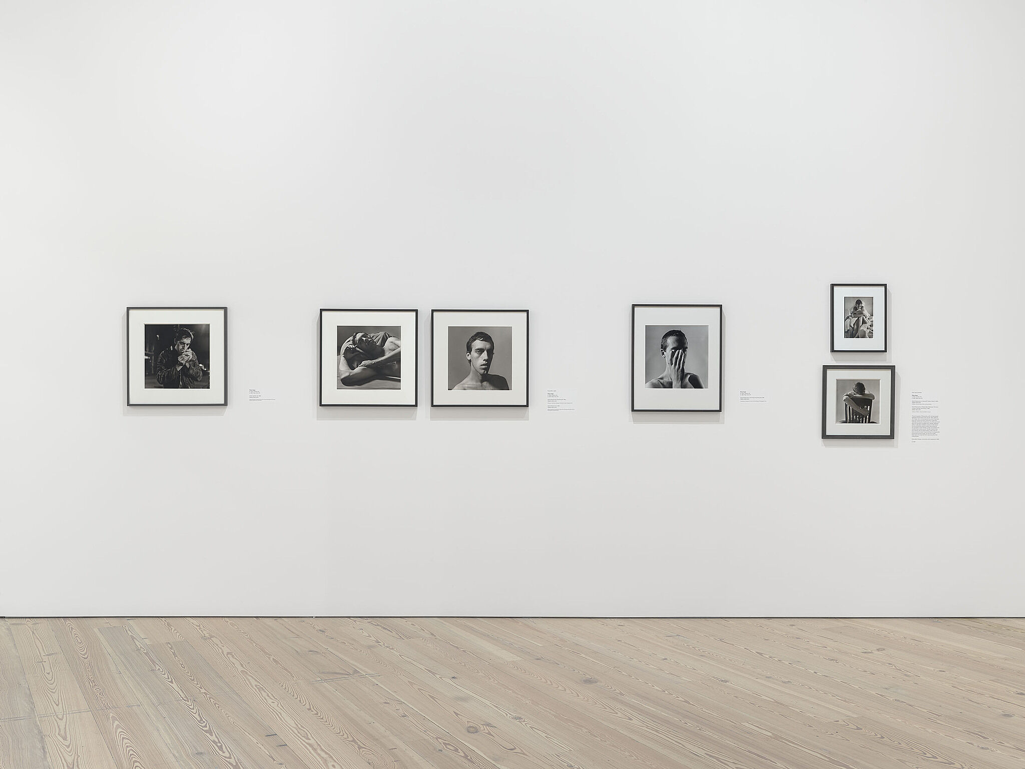 An image of the Whitney galleries with various photographs on the wall